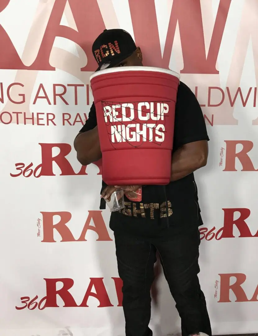 Person holding giant Red Cup Nights cooler