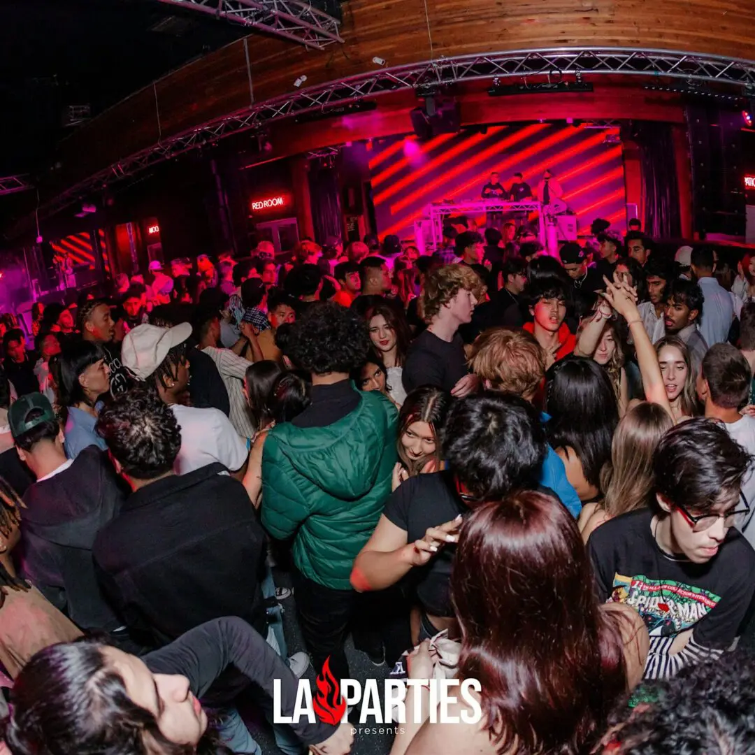 Crowded nightclub dance floor with DJ booth