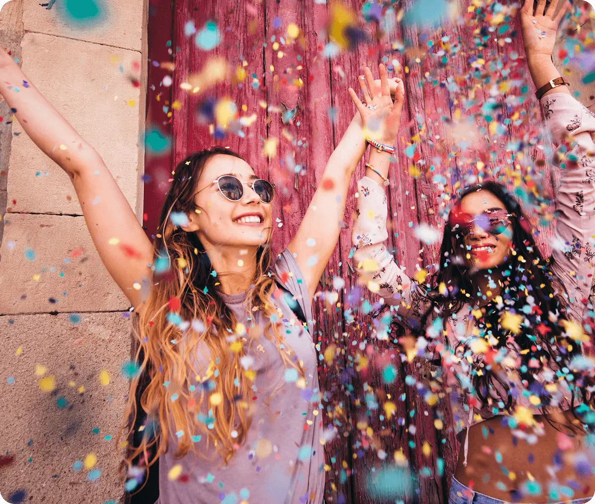Women celebrating with colorful confetti